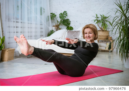 mature woman doing fitness on the mat at home mature woman doing fitness on the mat at home 97966476