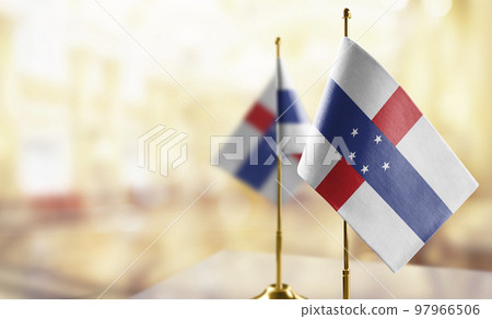 Small flags of the Netherlands Antilles on an abstract blurry background 97966506