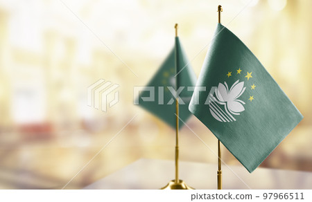 Small flags of the Macao on an abstract blurry background Small flags of the Macao on an abstract blurry background 97966511