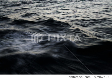 The texture of the raging winds and waves on the ocean in a monotone night off the Pacific Ocean taken from a fishing boat on the voyage. The texture of the raging winds and waves on the ocean in a monotone night off the Pacific Ocean taken from a fishing boat on the voyage. 97967402