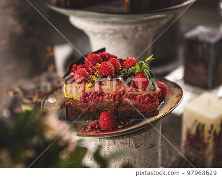 Slice of layered mousse chocolate cake 97968629