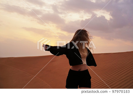 Young woman in the desert. The concept of happiness, freedom, travel Young woman in the desert. The concept of happiness, freedom, travel 97970183