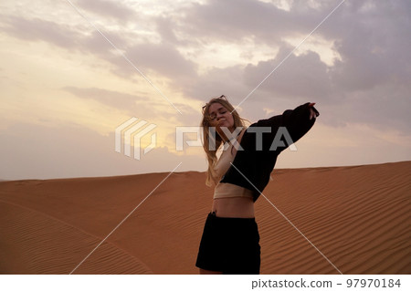 Young woman in the desert. The concept of happiness, freedom, travel Young woman in the desert. The concept of happiness, freedom, travel 97970184