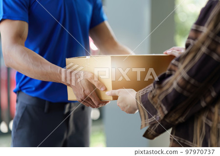 Asian courier with parcel and delivery logistic concept. Delivery man carrying package while customer carry 97970737