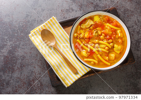 Rancho canario a typical Canary Islands dish with chickpeas and noodles closeup on the plate. Horizontal top view 97971334