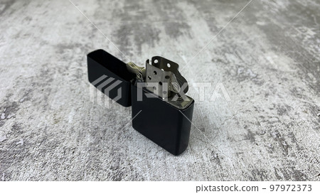 Petrol lighter lies on a light surface Petrol lighter lies on a light surface 97972373