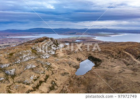Aerial view of the lake next to Agnish Lough by Maghery, Dungloe - County Donegal - Ireland. Aerial view of the lake next to Agnish Lough by Maghery, Dungloe - County Donegal - Ireland. 97972749