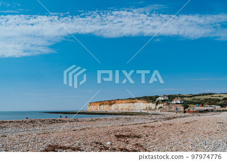 The Coast Guard Cottages and Seven Sisters Chalk Cliffs just outside Eastbourne, Sussex, England, UK. The Coast Guard Cottages and Seven Sisters Chalk Cliffs just outside Eastbourne, Sussex, England, UK. 97974776