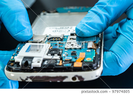 technician repairing inside of hard disk. Integrated Circuit. the concept of data, hardware, technician and technology. 97974805
