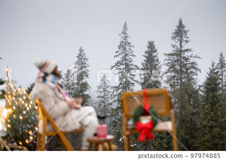 Woman in mountains on winter holidays Woman in mountains on winter holidays 97974885