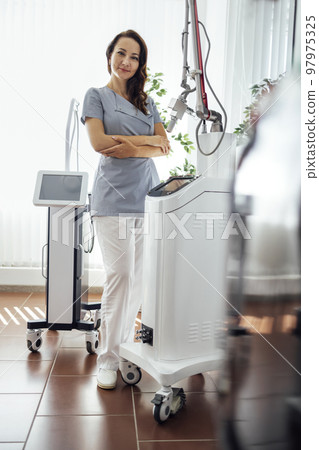 Cosmetologist dermatologist in a beauty clinic. Facial treatment 97975325