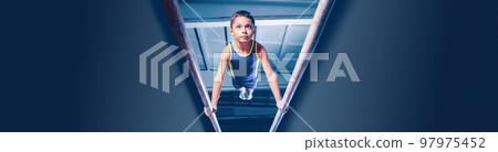 Image of little boy, child training, doing gymnastics exercises on parallel bars at gym. Developing strength and endurance Image of little boy, child training, doing gymnastics exercises on parallel bars at gym. Developing strength and endurance 97975452