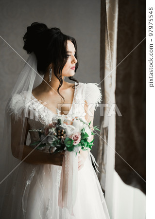 Portrait of stunning bride with long hair posing with great bouquet Portrait of stunning bride with long hair posing with great bouquet 97975548