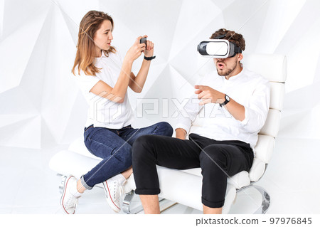 Couple having fun playing with virtual reality 97976845
