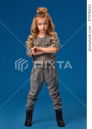 Little girl with a long curly hair in a fashionable clothes 97976922