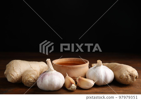 Fresh garlic and other natural cold remedies on wooden table. Space for text Fresh garlic and other natural cold remedies on wooden table. Space for text 97979351