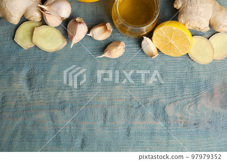 Fresh garlic and other natural cold remedies on light blue wooden table, flat lay. Space for text 97979352