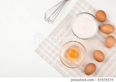 Flat lay composition with raw eggs and other ingredients on white table. Baking pie 97979374