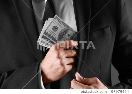 Man with bribe money on dark background, closeup Man with bribe money on dark background, closeup 97979434