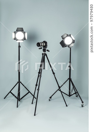Professional video camera and lighting equipment on grey background 97979480