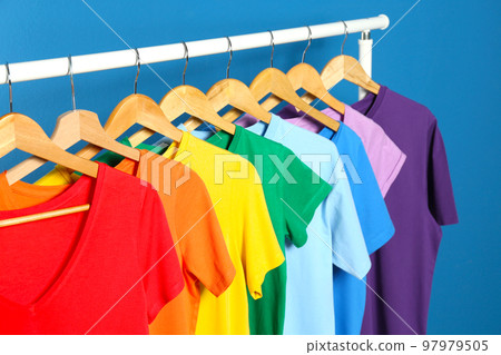 Bright clothes on blue background. Rainbow colors 97979505