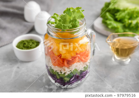 Healthy salad in glass jar on marble table Healthy salad in glass jar on marble table 97979516