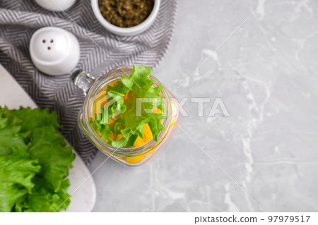 Healthy salad in glass jar on marble table, flat lay. Space for text Healthy salad in glass jar on marble table, flat lay. Space for text 97979517