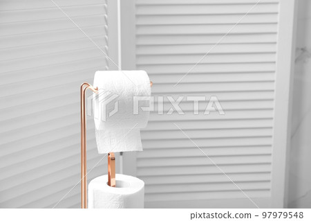 Holder with toilet paper rolls in bathroom 97979548