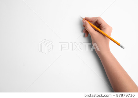 Woman holding pencil on white background, top view Woman holding pencil on white background, top view 97979730