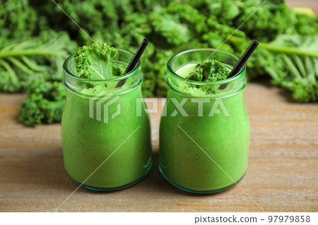 Tasty fresh kale smoothie on wooden table, closeup 97979858