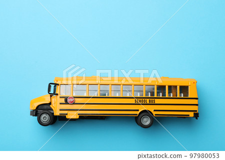 Yellow school bus on light blue background, top view with space for text. Transport service Yellow school bus on light blue background, top view with space for text. Transport service 97980053