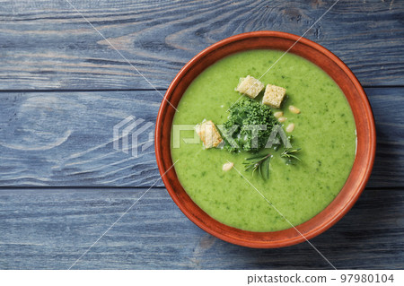 Tasty kale soup with croutons on blue wooden table, top view. Space for text Tasty kale soup with croutons on blue wooden table, top view. Space for text 97980104