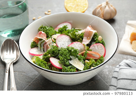 Tasty fresh kale salad on grey table, closeup Tasty fresh kale salad on grey table, closeup 97980113