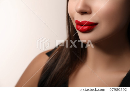 Beautiful woman with red lipstick on light background, closeup Beautiful woman with red lipstick on light background, closeup 97980292
