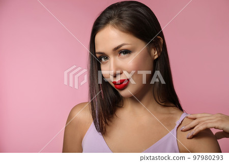 Beautiful woman with red lipstick on pink background Beautiful woman with red lipstick on pink background 97980293