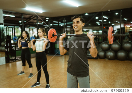 young asian man lifting barbell in front of his chest young asian man lifting barbell in front of his chest 97980339