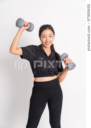 excited asian woman lifting dumbbells during fitness on isolated background excited asian woman lifting dumbbells during fitness on isolated background 97980688