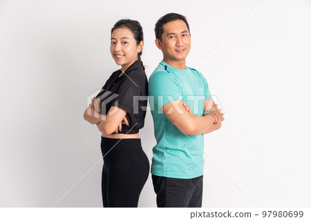 asian man and woman smiling standing back to back asian man and woman smiling standing back to back 97980699
