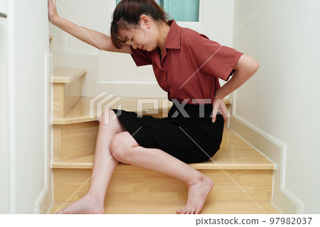 Asian lady woman injury from falling down on slippery surfaces stairs at home. Asian lady woman injury from falling down on slippery surfaces stairs at home. 97982037