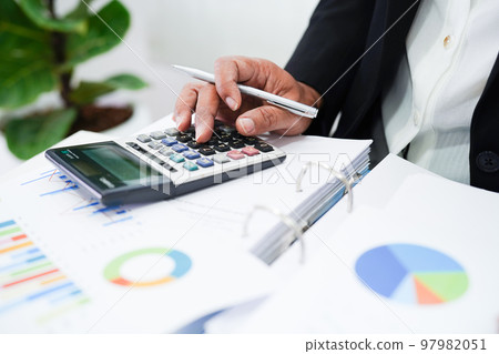 Business woman working and analysis with statistic graph in office. Business woman working and analysis with statistic graph in office. 97982051