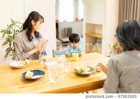 A family gathering in a dining kitchen A family gathering in a dining kitchen 97982680