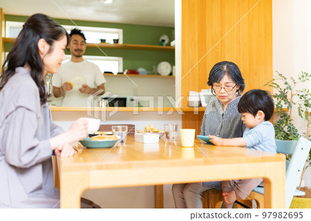 A family gathering in a dining kitchen 97982695