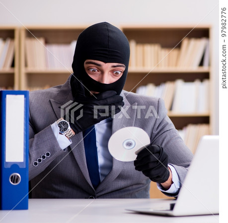 Criminal businessman with balaclava in office Criminal businessman with balaclava in office 97982776