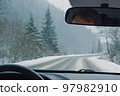 Driving through the winter snowy forest 97982910