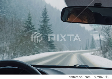 Driving through the winter snowy forest Driving through the winter snowy forest 97982910