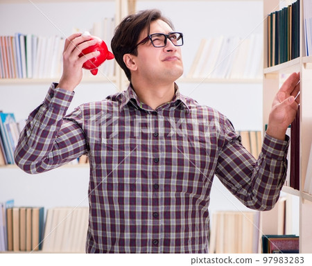 Young student in expensive textbooks concept Young student in expensive textbooks concept 97983283