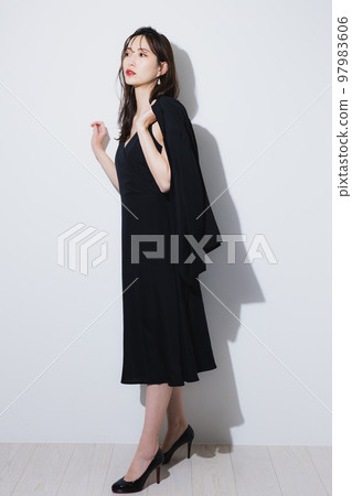 A woman in a black dress 97983606