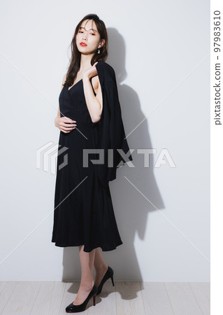 A woman in a black dress 97983610