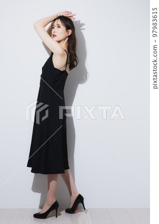 A woman in a black dress 97983615