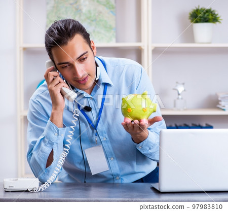 Young male travel agent working in the office 97983810